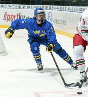 SPISSKA NOVA VES, SLOVAKIA - APRIL 16: Pavel Azhgirei #23 of Belarus plays the puck while Sweden's Adam Boqvist #3 defends during preliminary round action at the 2017 IIHF Ice Hockey U18 World Championship. (Photo by Steve Kingsman/HHOF-IIHF Images)