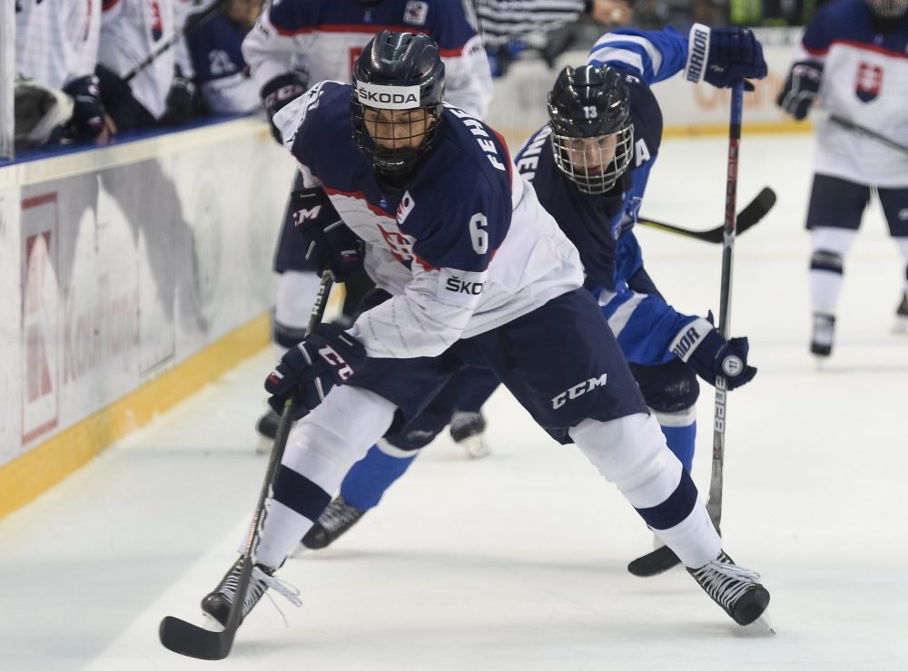 POPRAD, SLOVAKIA - APRIL 13: Slovakia's Martin Fehervary #6 passes the puck while Finland's Joni Ikonen #13  during preliminary round action at the 2017 IIHF Ice Hockey U18 World Championship. (Photo by Andrea Cardin/HHOF-IIHF Images)