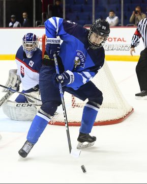 CHELYABINSK, RUSSIA - APRIL 19: Finland's Kaapo Kakko #33 plays the puck while while Slovakia's Nicolas Ferenyi #11 looks on during preliminary round action at the 2018 IIHF Ice Hockey U18 World Championship. (Photo by Andrea Cardin/HHOF-IIHF Images)