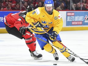 MONTREAL, CANADA - JANUARY 4: Canada's Thomas Chabot #5 stick checks Sweden's Rasmus Dahlin #8 during semifinal round action at the 2017 IIHF World Junior Championship. (Photo by Matt Zambonin/HHOF-IIHF Images)