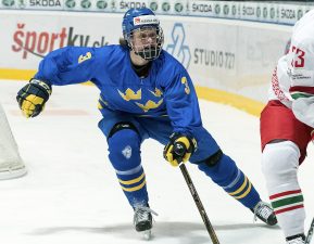 SPISSKA NOVA VES, SLOVAKIA - APRIL 16: Pavel Azhgirei #23 of Belarus plays the puck while Sweden's Adam Boqvist #3 defends during preliminary round action at the 2017 IIHF Ice Hockey U18 World Championship. (Photo by Steve Kingsman/HHOF-IIHF Images)