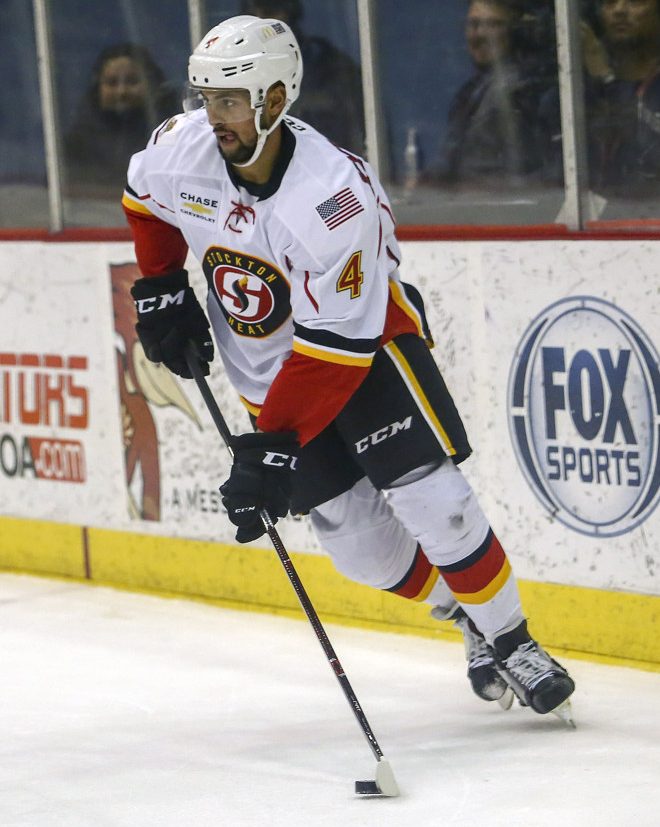 TUCSON, AZ - DECEMBER 23: Stockton Heat defenseman Oliver Kylington (4) controls the puck during a hockey game between the Stockton Heat and Tucson Roadrunners on December 23, 2017, at Tucson Convention Center in Tucson, AZ. Stockton Heat defeats Tucson Roadrunners 2-1. (Photo by Jacob Snow/Icon Sportswire)