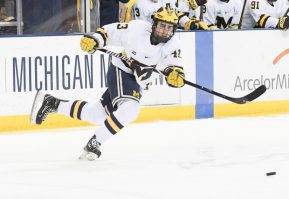 ANN ARBOR, MI - MARCH 03: Michigan Wolverines defenseman Quinn Hughes (43) passes the puck during the Michigan Wolverines game versus the Wisconsin Badgers in the BIG10 Hockey Tournament on March 3, 2018, at Red Berenson Rink at Yost Ice Arena in Ann Arbor, Michigan. (Photo by Steven King/Icon Sportswire)
