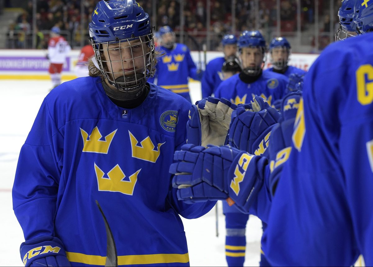 CHELYABINSK, RUSSIA - APRIL 29: Sweden's Marcus Westfalt #26 celebrates at the bench after scoring a first period goal against the Czech Republic during bronze medal game action at the 2018 IIHF Ice Hockey U18 World Championship. (Photo by Steve Kingsman/HHOF-IIHF Images)