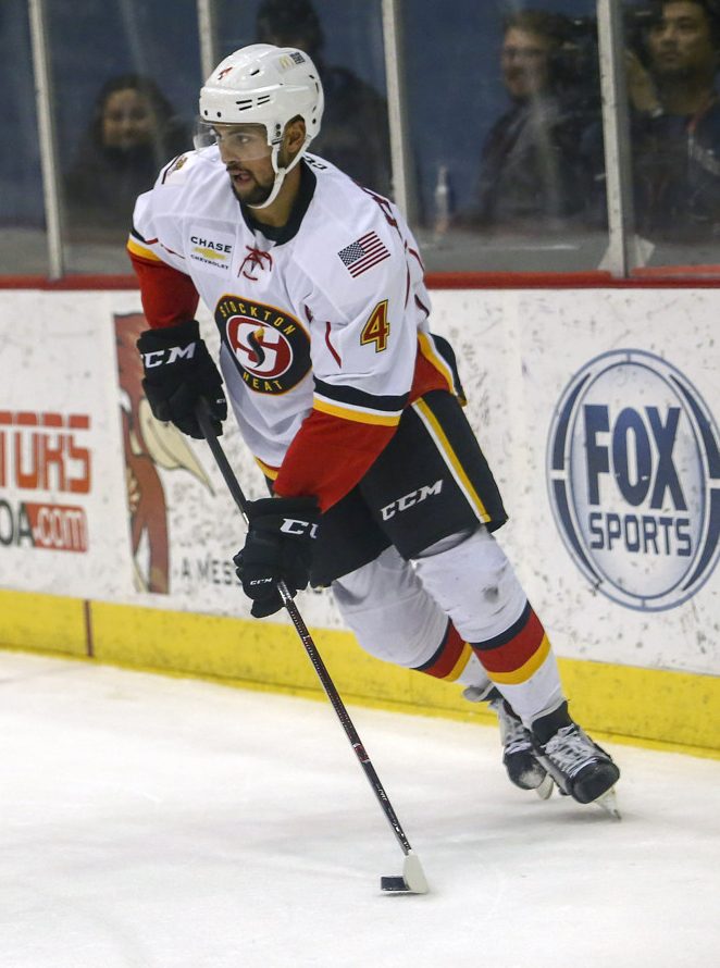 TUCSON, AZ - DECEMBER 23: Stockton Heat defenseman Oliver Kylington (4) controls the puck during a hockey game between the Stockton Heat and Tucson Roadrunners on December 23, 2017, at Tucson Convention Center in Tucson, AZ. Stockton Heat defeats Tucson Roadrunners 2-1. (Photo by Jacob Snow/Icon Sportswire)