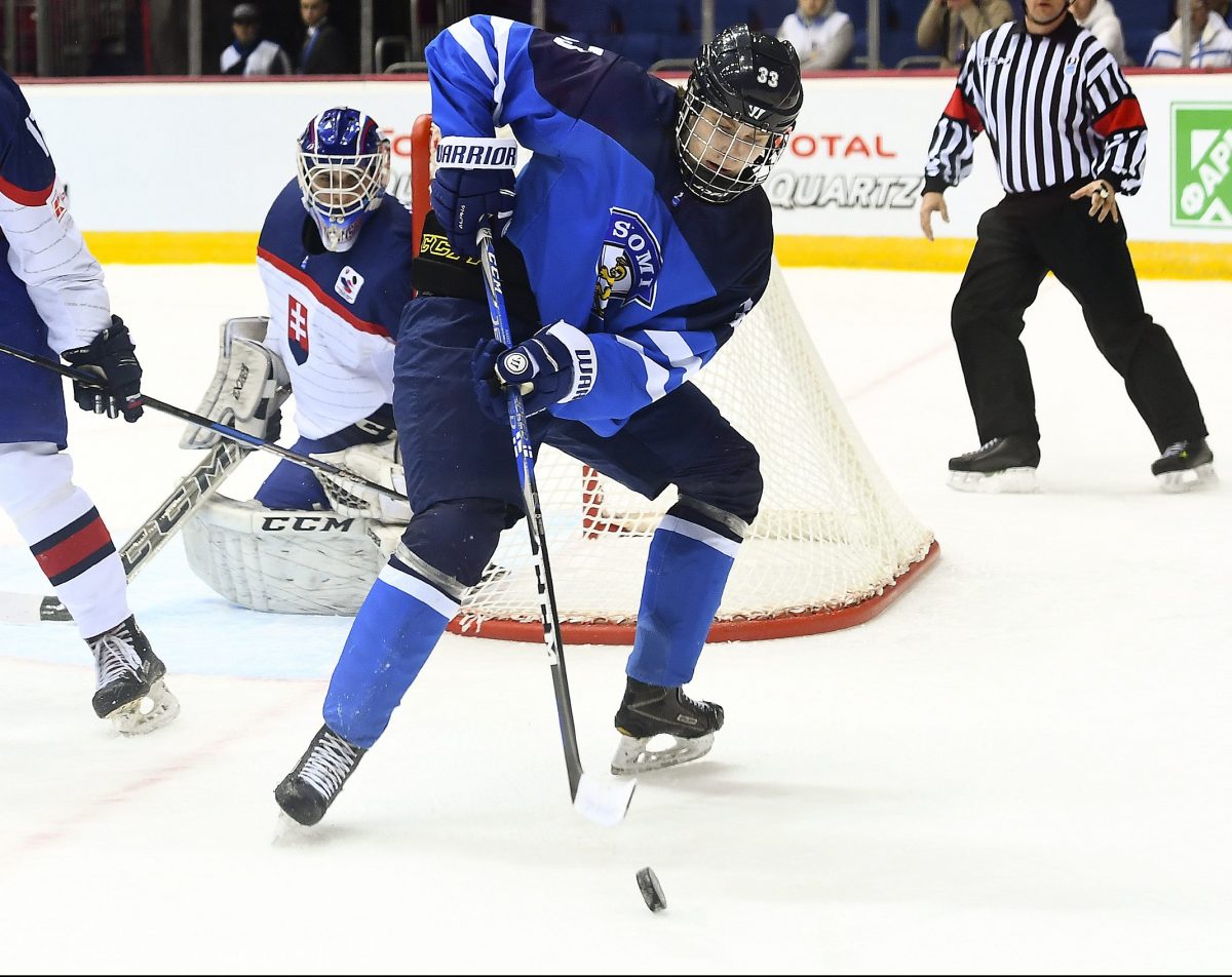 CHELYABINSK, RUSSIA - APRIL 19: Finland's Kaapo Kakko #33 plays the puck while while Slovakia's Nicolas Ferenyi #11 looks on during preliminary round action at the 2018 IIHF Ice Hockey U18 World Championship. (Photo by Andrea Cardin/HHOF-IIHF Images)