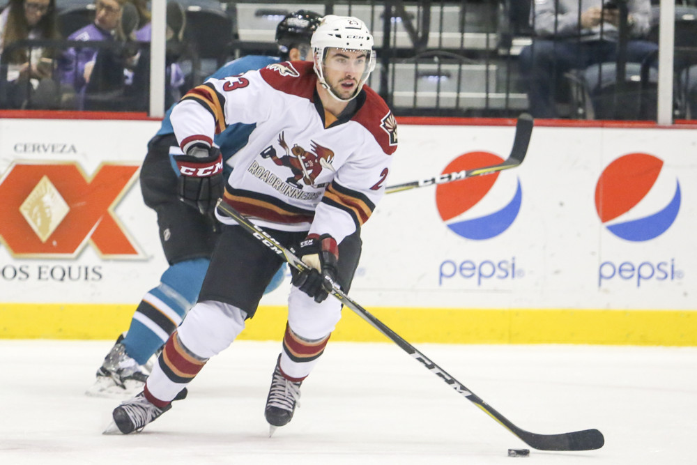 TUCSON, AZ - DECEMBER 12: Tucson Roadrunners defenseman Kyle Capobianco (23) controls the puck during a hockey game between the San Jose Barracuda and Tuscon Roadrunners on December 12, 2017, at Tucson Convention Center in Tucson, AZ. San Jose Barracuda defeated Tucson Roadrunners 3-2. (Photo by Jacob Snow/Icon Sportswire)
