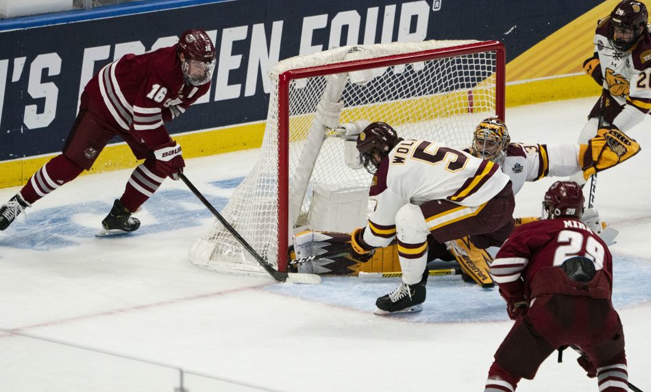 BUFFALO, NY - APRIL 13: Massachusetts Minutemen Defenseman Cale Makar (16) takes a shot on goal with Minnesota Duluth Bulldogs Defenseman Nick Wolff (5) defending and Minnesota Duluth Bulldogs Goaltender Hunter Shepard (32) defending during the first period of the NCAA Hockey Frozen Four championship game between the Massachusetts Minutemen and the Minnesota Duluth Bulldogs on April 13, 2019, at KeyBank Center in Buffalo, NY. (Photo by Gregory Fisher/Icon Sportswire)