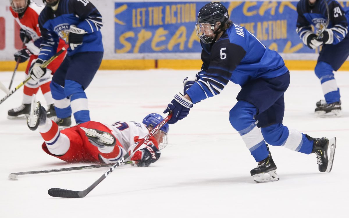 UMEA, SWEDEN - APRIL 21: Finland's Santeri Hatakka #6 stickhandles the puck against Czech Republic's Radek Kucerik #20 falls to the ice during the preliminary round of the 2019 IIHF Ice Hockey U18 World Championship at A3 Arena on April 21, 2019 in Umea, Sweden. (Photo by Chris Tanouye/HHOF-IIHF Images)