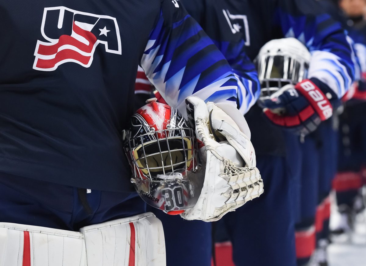 ORNSKOLDSVIK, SWEDEN - APRIL 19: USAs Spencer Knight #30 holds his mask during the national anthem following a 12-5 preliminary round win against Slovakia at the 2019 IIHF Ice Hockey U18 World Championship at Fjallraven Center on April 19, 2019 in Ornskoldsvik, Sweden. (Photo by Steve Kingsman/HHOF-IIHF Images)