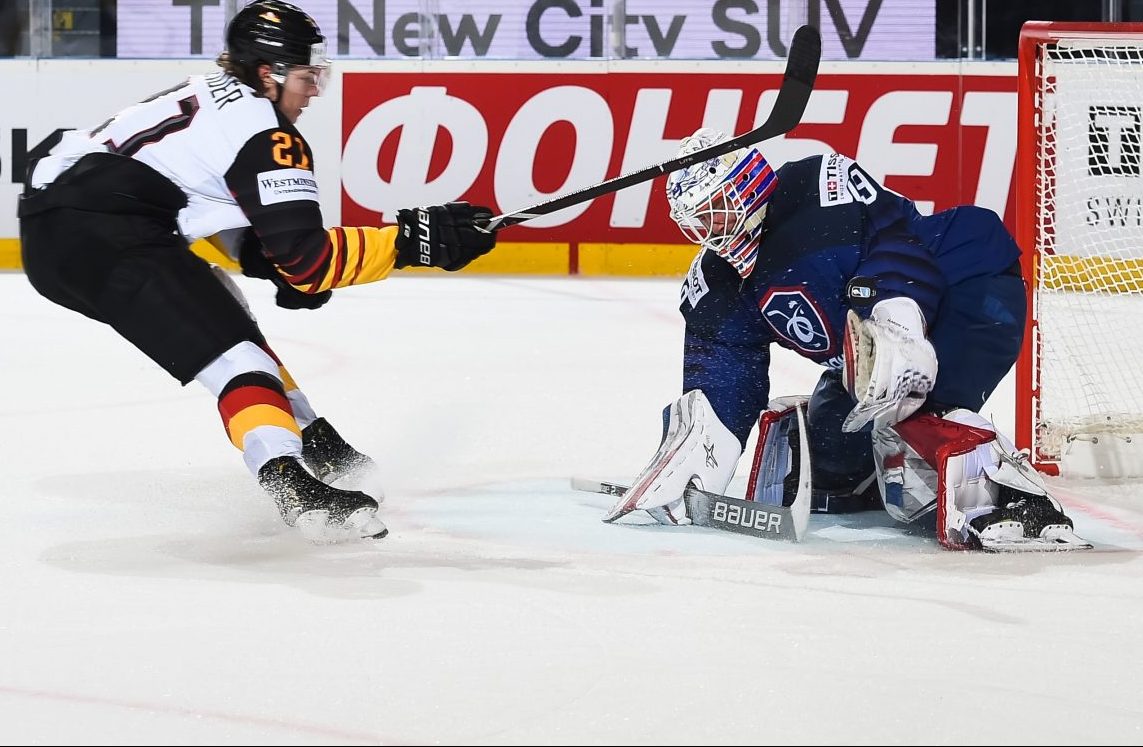 KOSICE, SLOVAKIA - MAY 14: Germany's Moritz Seider #21 scores on France's Florian Hardy #49 in the first period during preliminary round action of the 2019 IIHF Ice Hockey World Championship at Steel Arena on May 14, 2019 in Kosice, Slovakia. (Photo by Matt Zambonin/HHOF-IIHF Images)