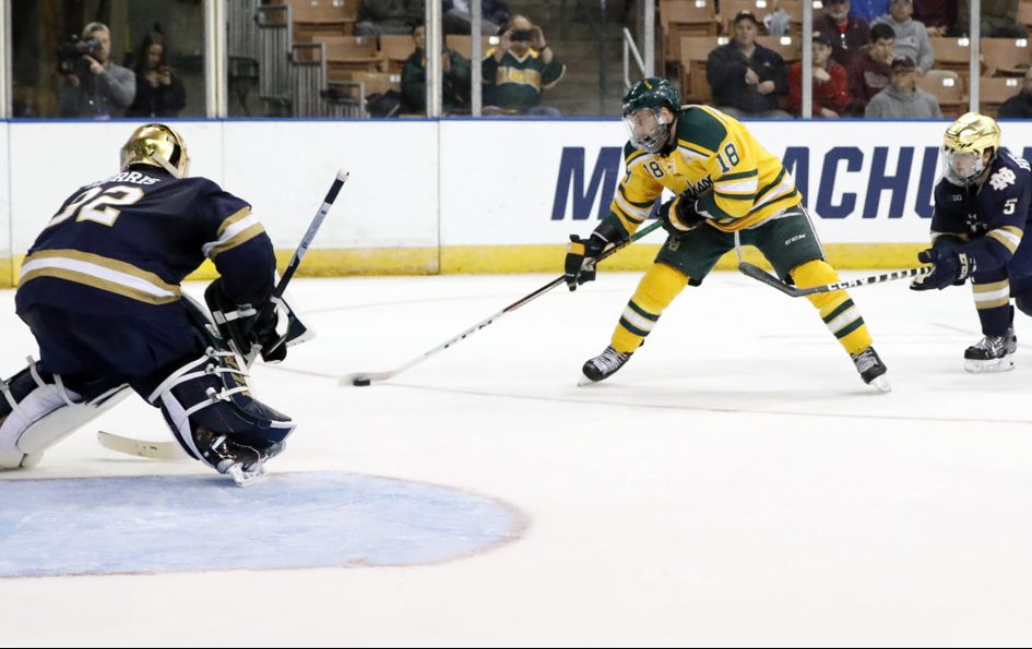 MANCHESTER, NH - MARCH 29: Clarkson University Golden Knights forward Haralds Egle (18) breaks in on Notre Dame Fighting Irish goaltender Cale Morris (32) during a Northeast Regional semi-final between the Notre Dame Fighting Irish and the Clarkson Golden Knights on March 29, 2019, at SNHU Arena in Manchester, NH. (Photo by Fred Kfoury III/Icon Sportswire)