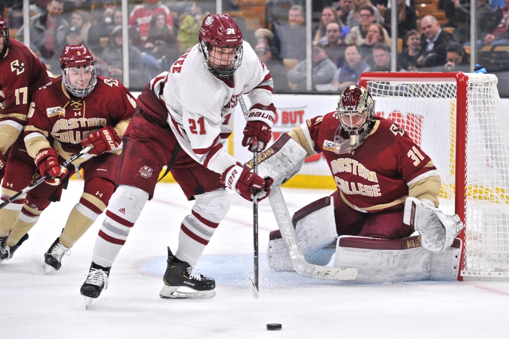 BOSTON, MA - MARCH 22: Massachusetts Minutemen forward Mitchell Chaffee (21) tries to put the puck past Boston College Eagles goaltender Joseph Woll (31). During the University of Massachusetts Minutemen game against the Boston College Eagles on March 22, 2019 at TD Garden in Boston, MA. (Photo by Michael Tureski/Icon Sportswire)