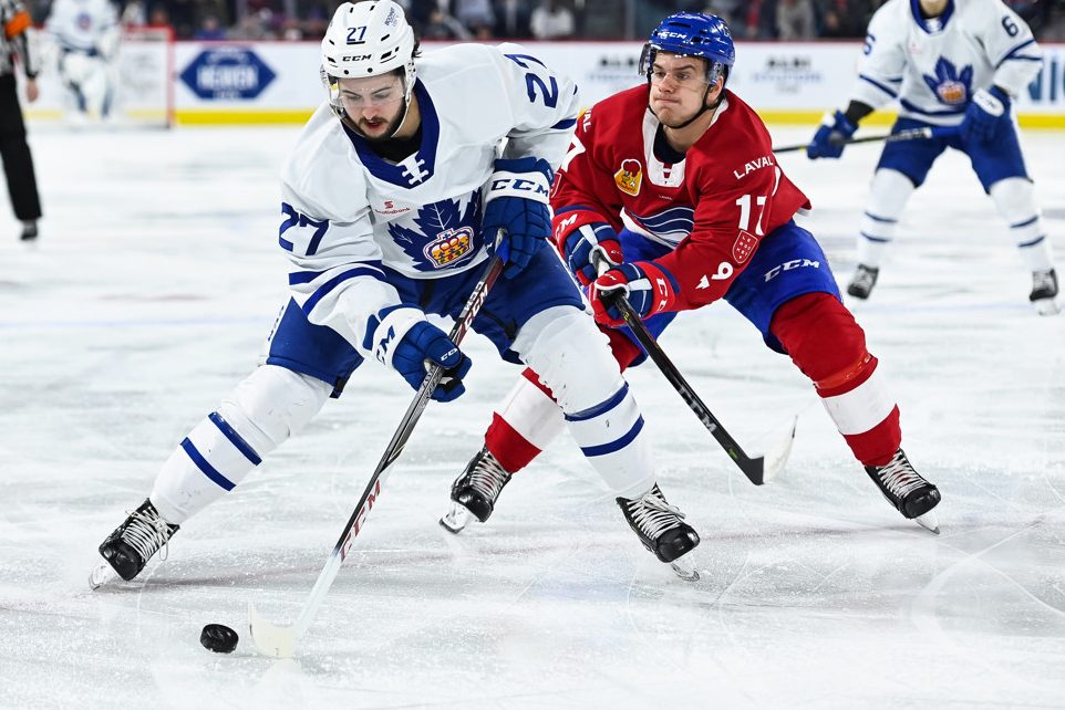 LAVAL, QC - MARCH 06: Toronto Marlies right wing Jeremy Bracco (27) tries to maintain control of the puck while under pressure from Laval Rocket center Hayden Verbeek (17) during the Toronto Marlies versus the Laval Rocket game on March 06, 2019, at Place Bell in Laval, QC  (Photo by David Kirouac/Icon Sportswire)