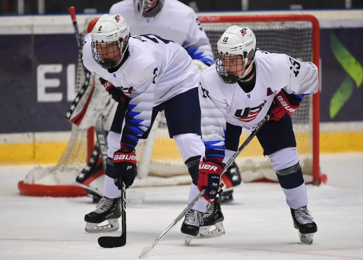 ORNSKOLDSVIK, SWEDEN - APRIL 25: USA's Cam York #2 and Cole Caufield #13 look on during quarterfinal round action against Finland at the 2019 IIHF Ice Hockey U18 World Championship at Fjallraven Center on April 25, 2019 in Ornskoldsvik, Sweden. (Photo by Steve Kingsman/HHOF-IIHF Images)