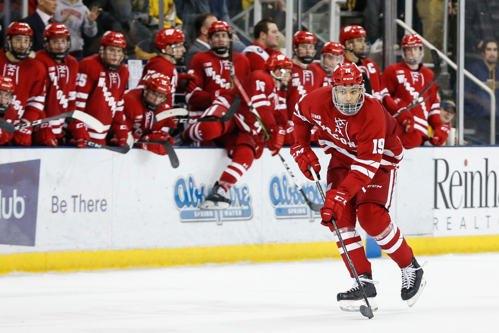 ANN ARBOR, MI - NOVEMBER 24:  Wisconsin Badgers defenseman K'Andre Miller (19) skates with the puck during a regular season Big 10 Conference hockey game between the Wisconsin Badgers and Michigan Wolverines on November 24, 2018 at Yost Ice  Arena in Ann Arbor, Michigan.  (Photo by Scott W. Grau/Icon Sportswire)