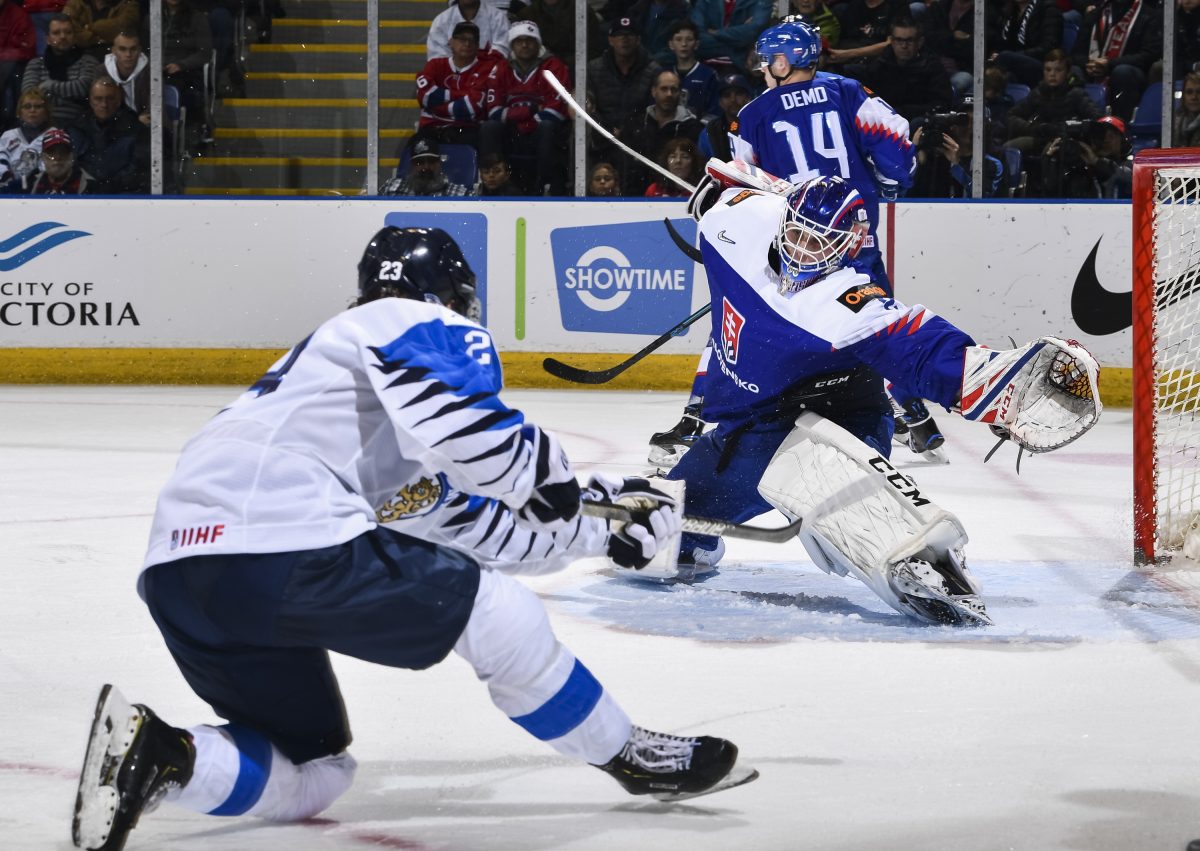 VICTORIA, BC - DECEMBER 29: Finland's Linus Nyman #23 takes a shot on Slovakia's Samuel Hlavaj #2 during preliminary round action at the 2019 IIHF World Junior Championship at Save-On-Foods Memorial Centre on December 29, 2018 in Victoria, BC Canada. (Photo by Minas Panagiotakis/HHOF-IIHF Images)