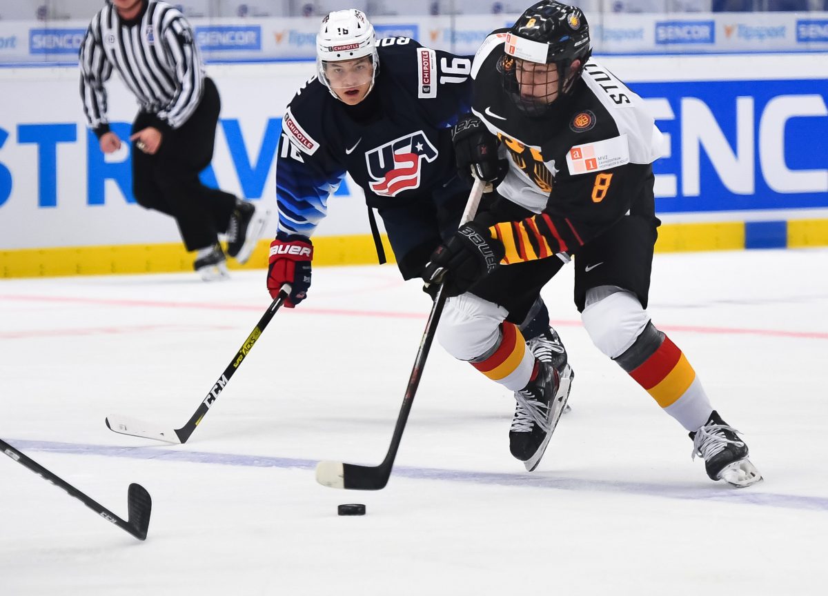 OSTRAVA, CZECH REPUBLIC - DECEMBER 27: GermanyÕs Tim Stutzle #8 skates with the puck while USAÕs Nicholas Robertson #16 chases him down during preliminary round action at the 2020 IIHF World Junior Championship at Ostravar Arena on December 27, 2019 in Ostrava, Czech Republic. (Photo by Andrea Cardin/HHOF-IIHF Images)