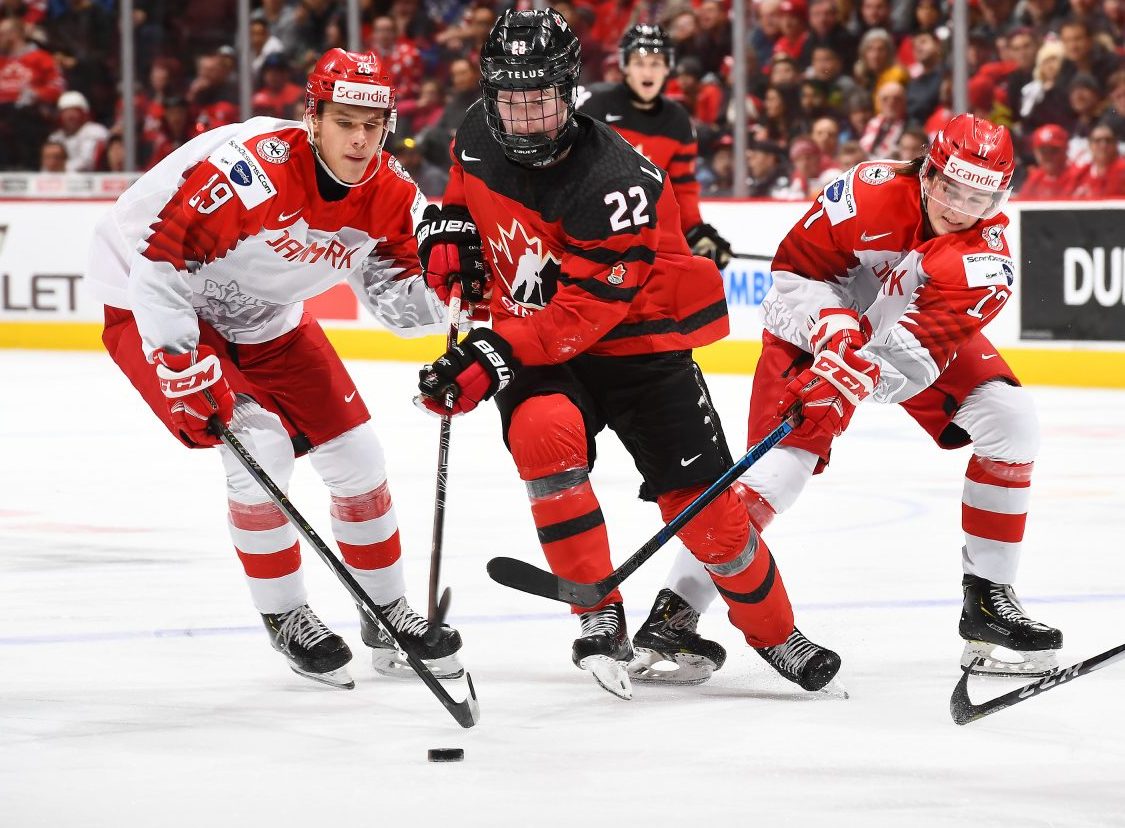 VANCOUVER, BC - DECEMBER 26: Canada's Alexis Lafreniere #22 skates with the puck while Denmark's Victor Cubars #29 and Lucas Andersen #17 chase him down during preliminary round action at the 2019 IIHF World Junior Championship at Rogers Arena on December 26, 2019 in Vancouver, BC Canada. (Photo by Matt Zambonin/HHOF-IIHF Images)