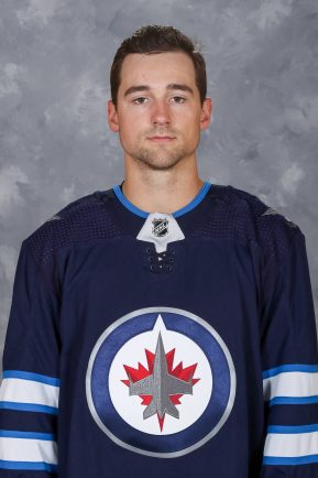 WINNIPEG, MB - SEPTEMBER 12: Neal Pionk #4 of the Winnipeg Jets poses for his official headshot for the 2019-2020 season on September 12, 2019 at the Bell MTS Iceplex in Winnipeg, Manitoba, Canada. (Photo by Jonathan Kozub/NHLI via Getty Images) *** Local Caption *** Neal Pionk