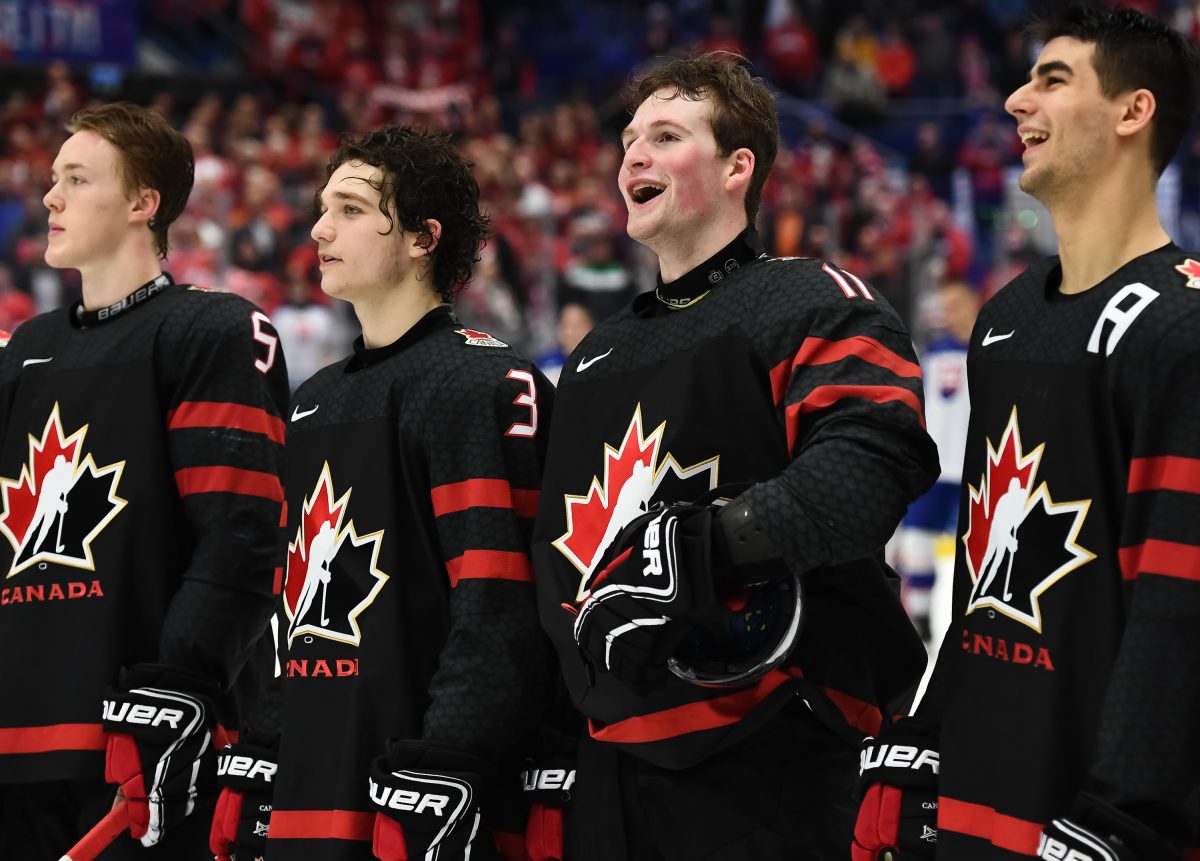 OSTRAVA, CZECH REPUBLIC - JANUARY 2: Canada's Joe Veleno #9, Alexis Lafreniere #11, Calen Addison #3 and Jacob Bernard-Docker #5 look on during the Canadian national anthem following a 6-1 quarterfinal round win against Slovakia at the 2020 IIHF World Junior Championship at Ostravar Arena on January 2, 2020 in Ostrava, Czech Republic. (Photo by Andrea Cardin/HHOF-IIHF Images)