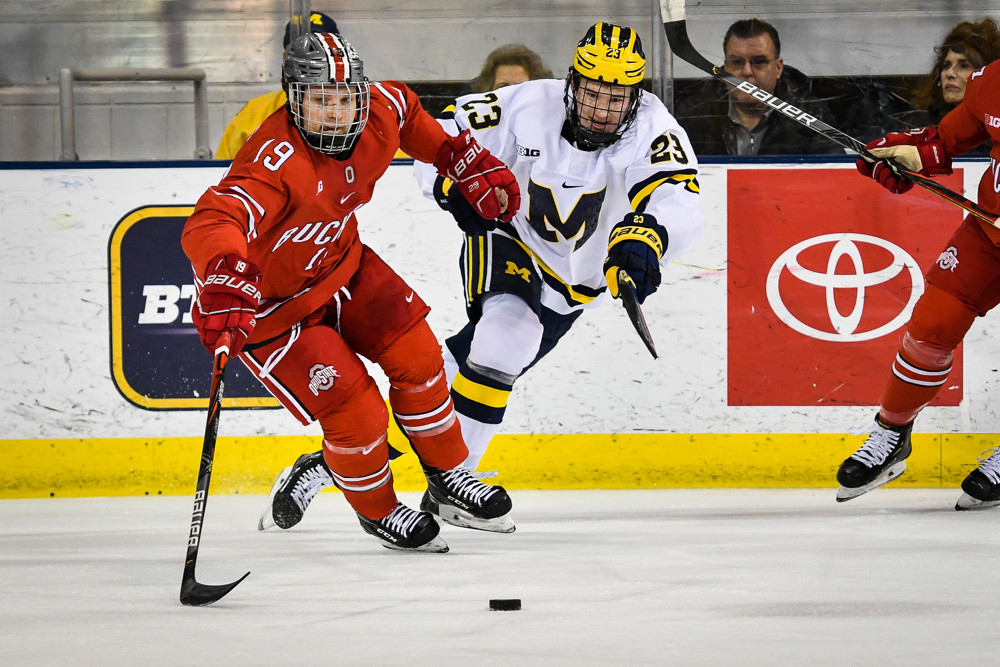 ANN ARBOR, MI - JANUARY 31: Ohio State Buckeyes forward Matthew Jennings (19) moves the puck away from Michigan Wolverines forward Jimmy Lambert (23) during the Michigan Wolverines game versus the Ohio State Buckeyes on Friday January 31, 2020 at Yost Ice Arena Center in Ann Arbor, MI. (Photo by Steven King/Icon Sportswire)