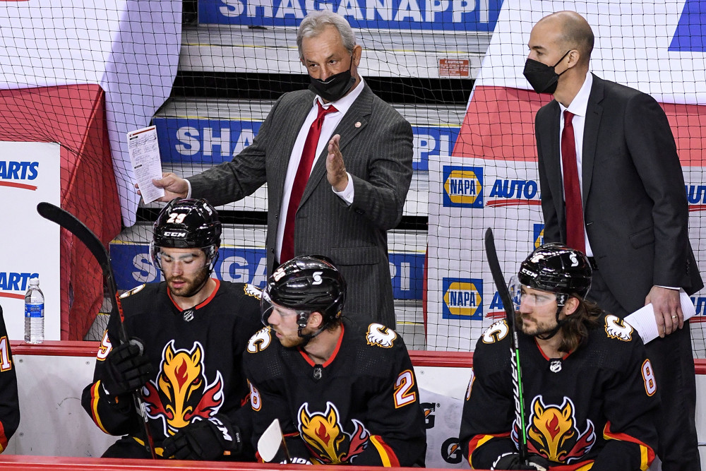 CALGARY, AB - MARCH 11: Calgary Flames head coach Darryl discusses a play with assistant coach Ryan Huska during the first period of an NHL game where the Calgary Flames hosted the Montreal Canadiens on March 11, 2021, at the Scotiabank Saddledome in Calgary, AB. (Photo by Brett Holmes/Icon Sportswire)